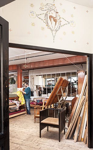 Jonathan busy in the workshop, where a chaise longue is being covered in Manuel Canovas embroidered fabric, and where a Vienna Secession chair waits to be upholstered with John Boyd horsehair