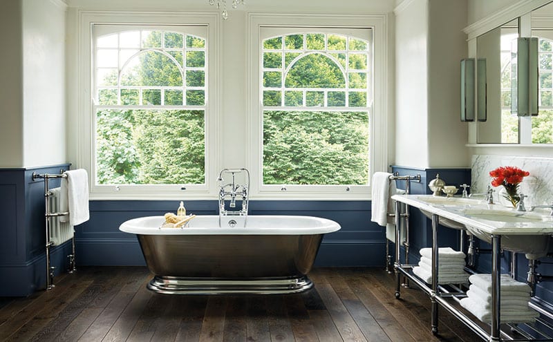 The classic white and chrome theme is extended to the shower and bath, with everything set off beautifully by the dark-blue panelling