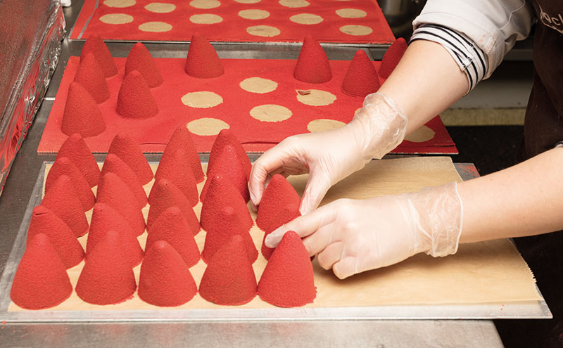 every season requires chocolate- here chocolate Santa hats are being prepped to be added to one of Ruth’s creations