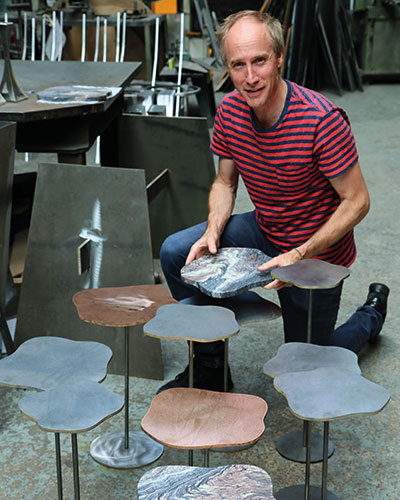 Tom Faulkner fixes a marble Lily table top to its steel stem