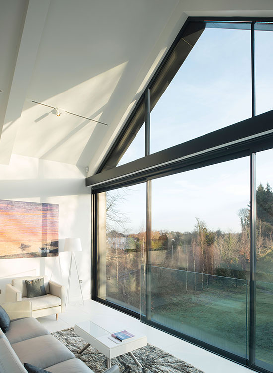 Inside the floating element is the master suite – a sitting room with a mezzanine bedroom – that makes the most of the views. IDSystems supplied the sliding doors, Juliet balcony and angled fixed-frame gable-end glazing