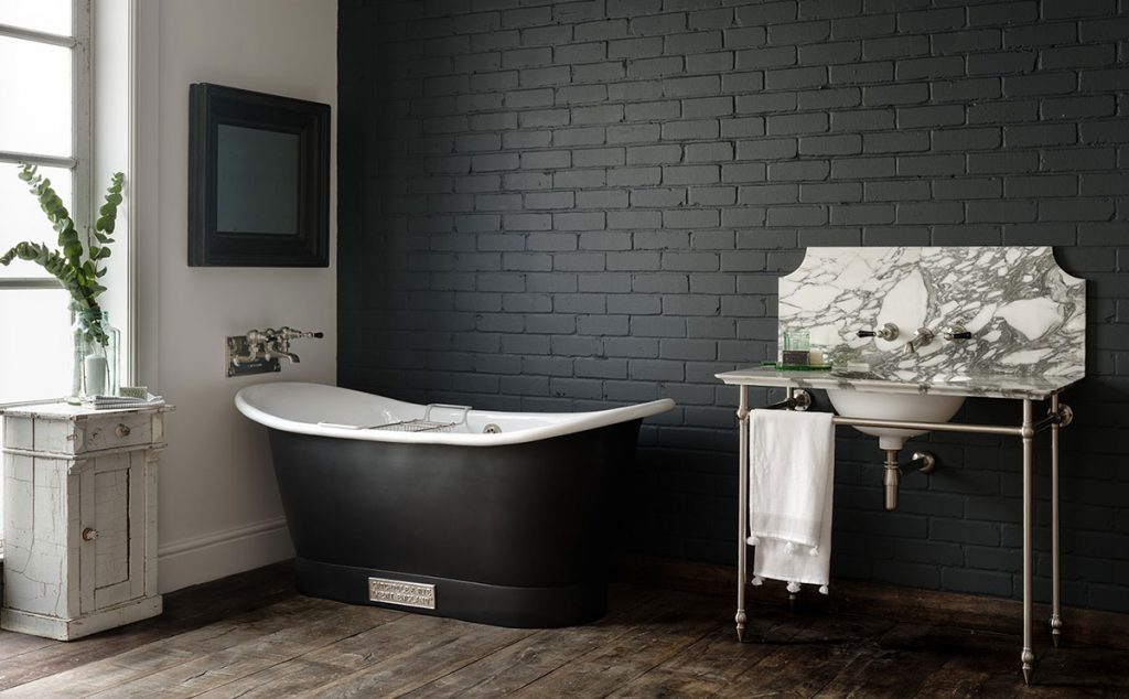 dark bathroom with marble sink by Catchpole & Rye