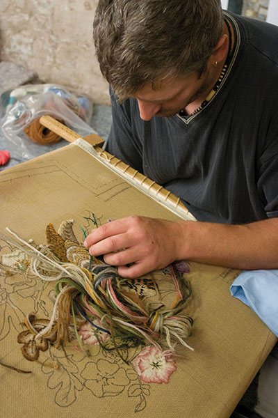man-embroidering-a-floral-pattern