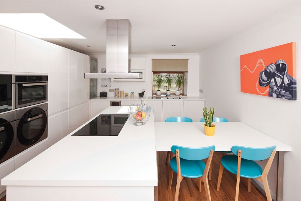modern-kitchen-with-blue-chairs-and-orange-art-print