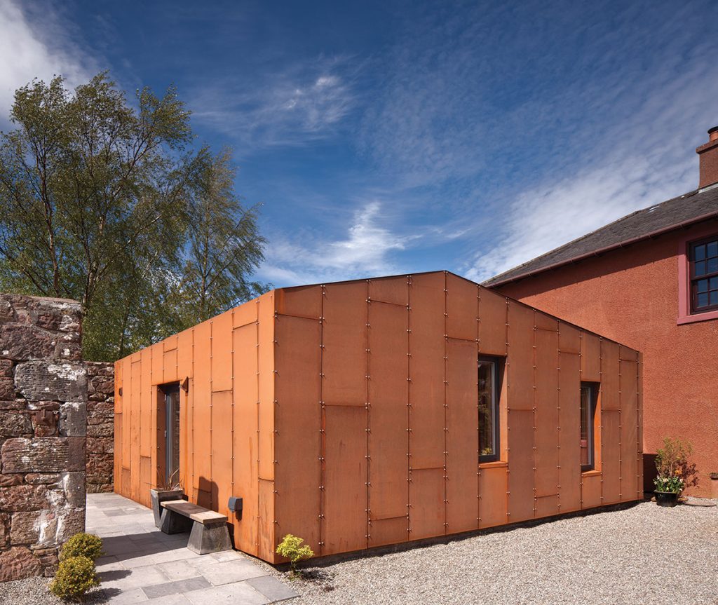 terracotta coloured extension against blue sky