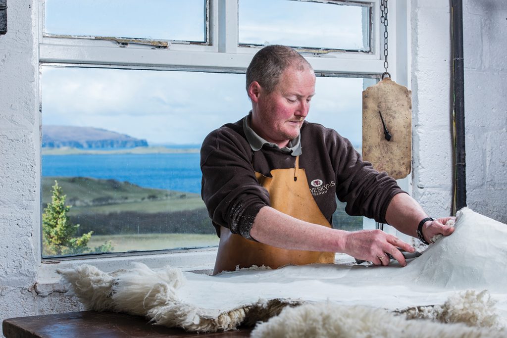 Pete-trims-the-sheepskin-with-a-sharp-blade