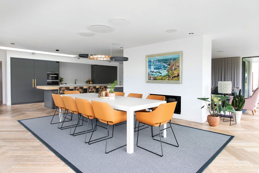 dining-area-in-open-plan-kitchen-with-orange-chairs