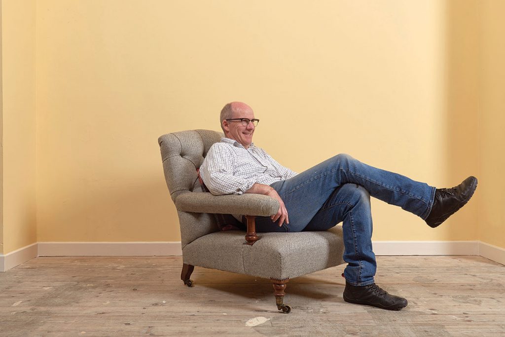 sitting-on-a-chair-in-a-yellow-room