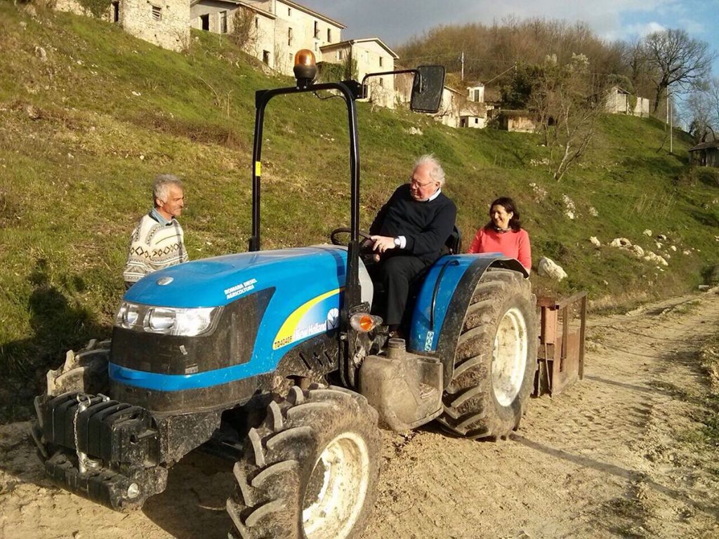 older-man-driving-blue-tractor