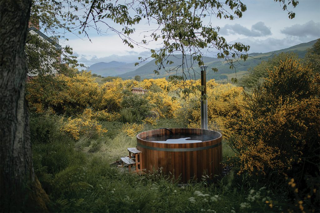 Wood fired hot tub nestled in the woodland