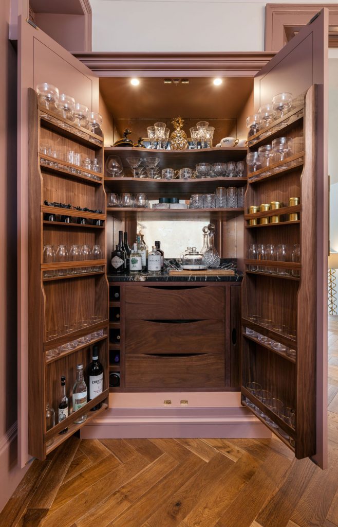 One of the larder cabinets opens to reveal a bar, complete with mirrored back and oak detailing