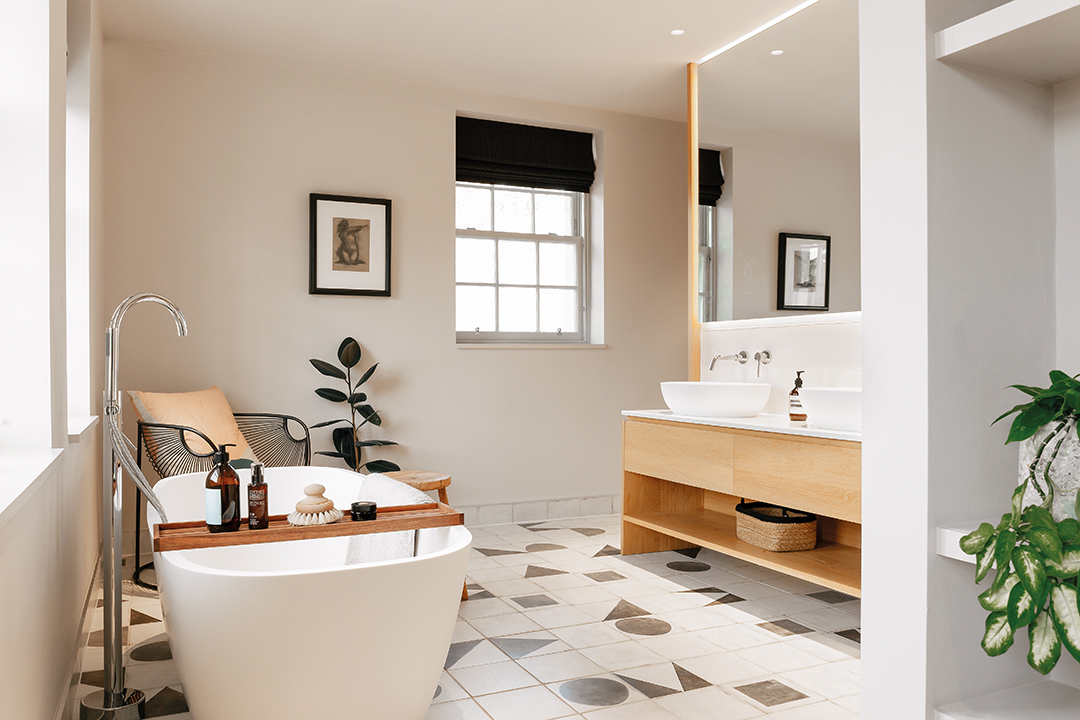 freestanding tub, wooden vanity unit, patterned floor