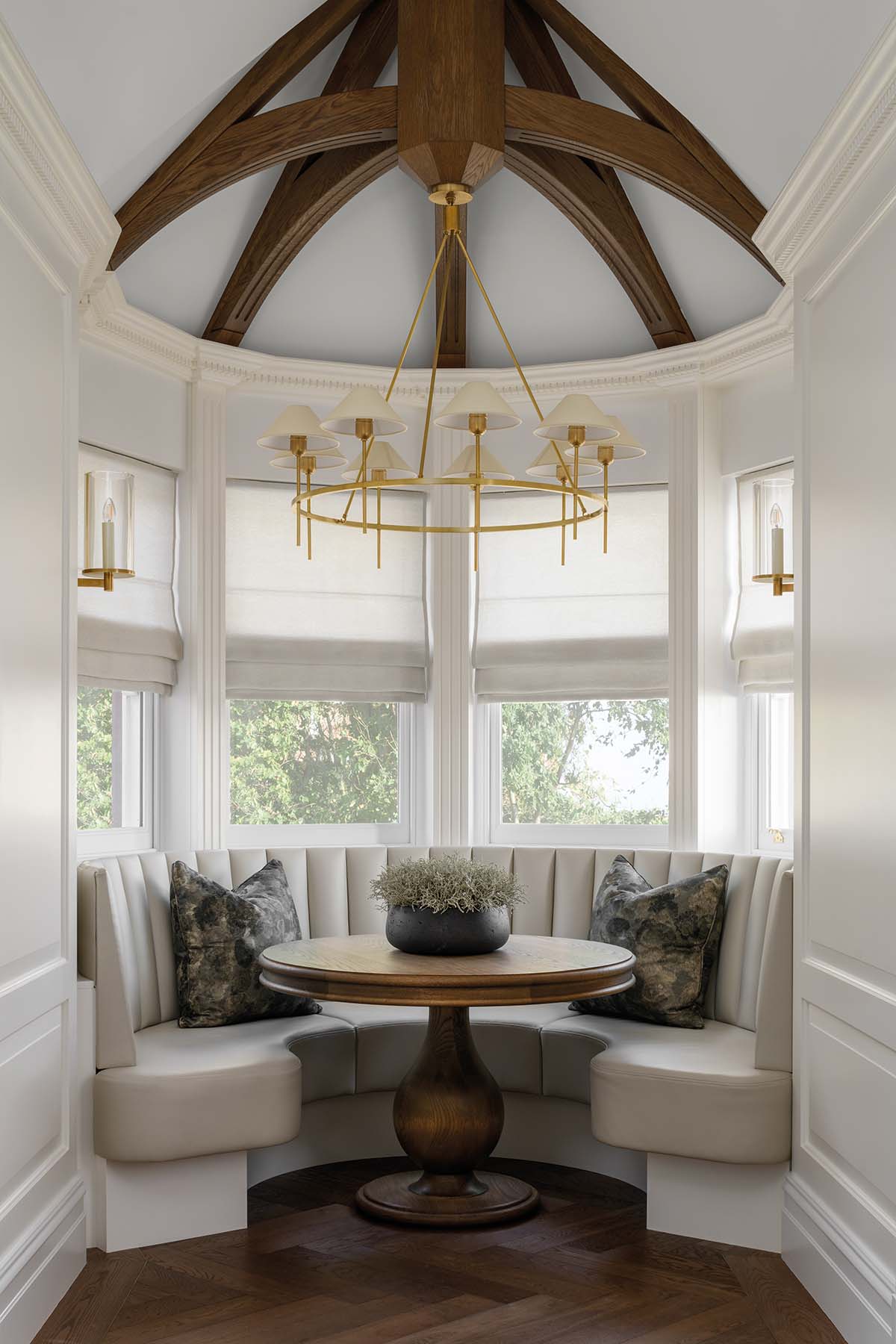 window nook with banquette seating and domed ceiling with oak beamed struts