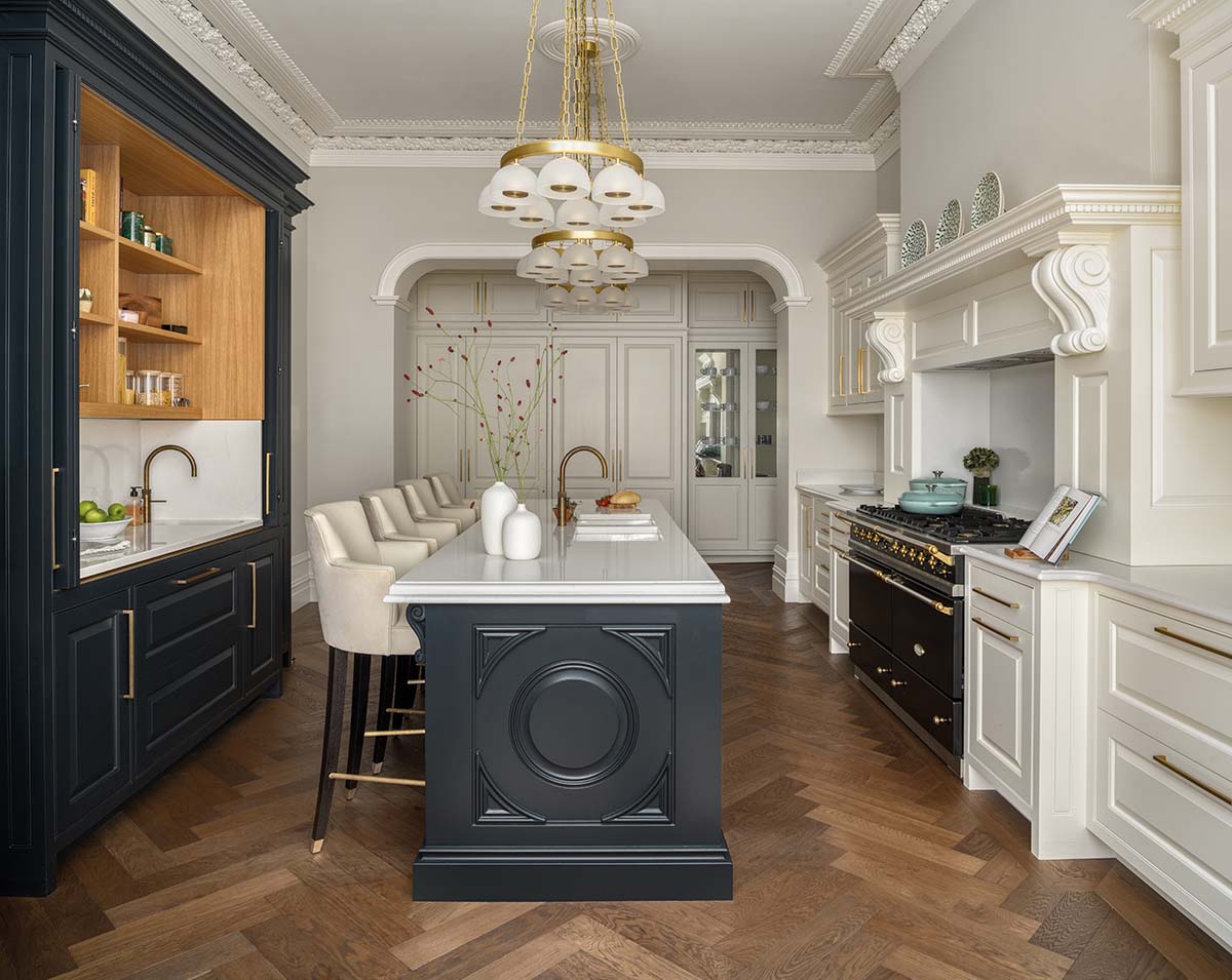 alternative view of the kitchen with navy painted island and pendant lighting on display 