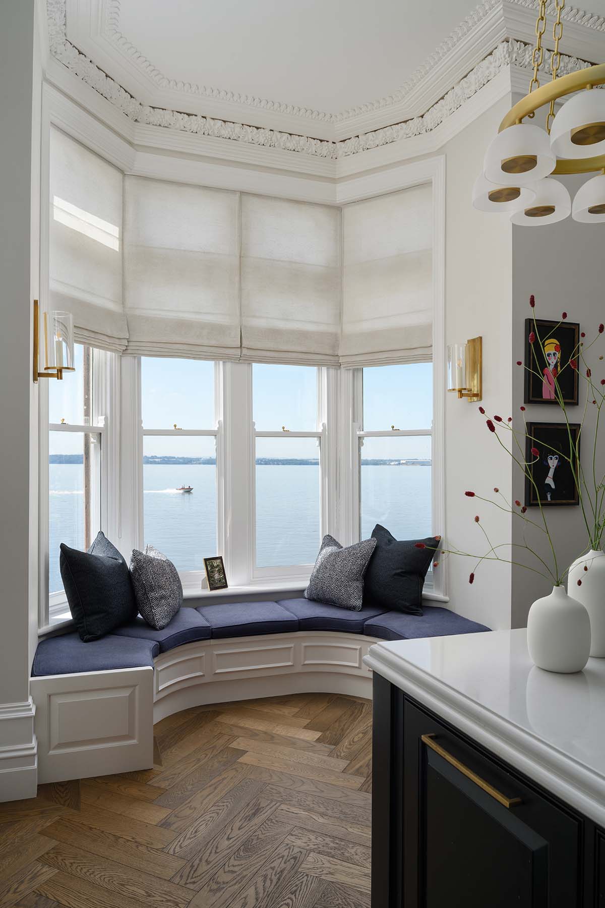 a window nook in blue and white with views out to the water