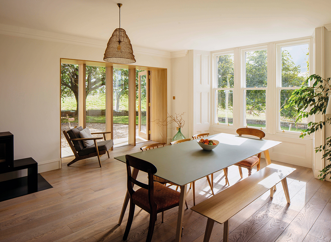 interior view, open plan kitchen-dining space. lots of glass and views out to fields outside 