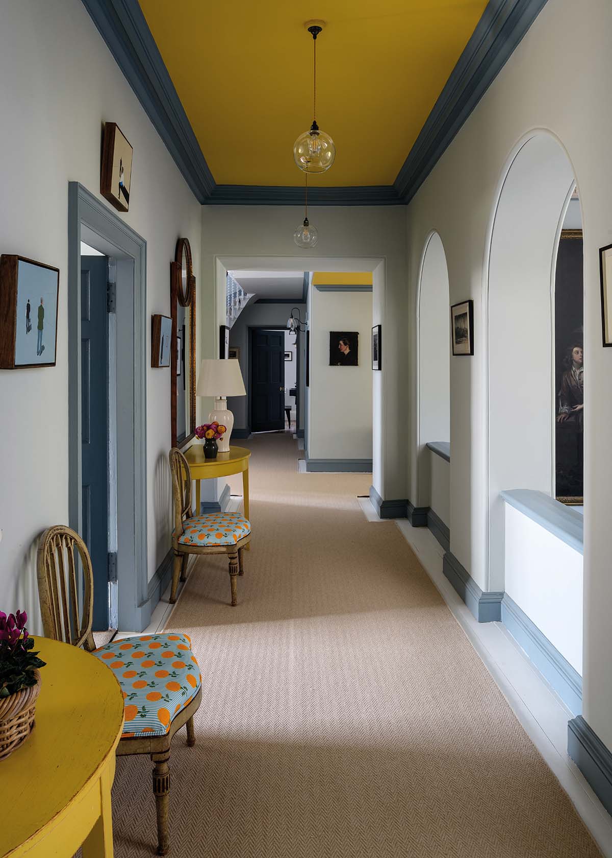 hallway with yellow ceiling and yellow furniture accents