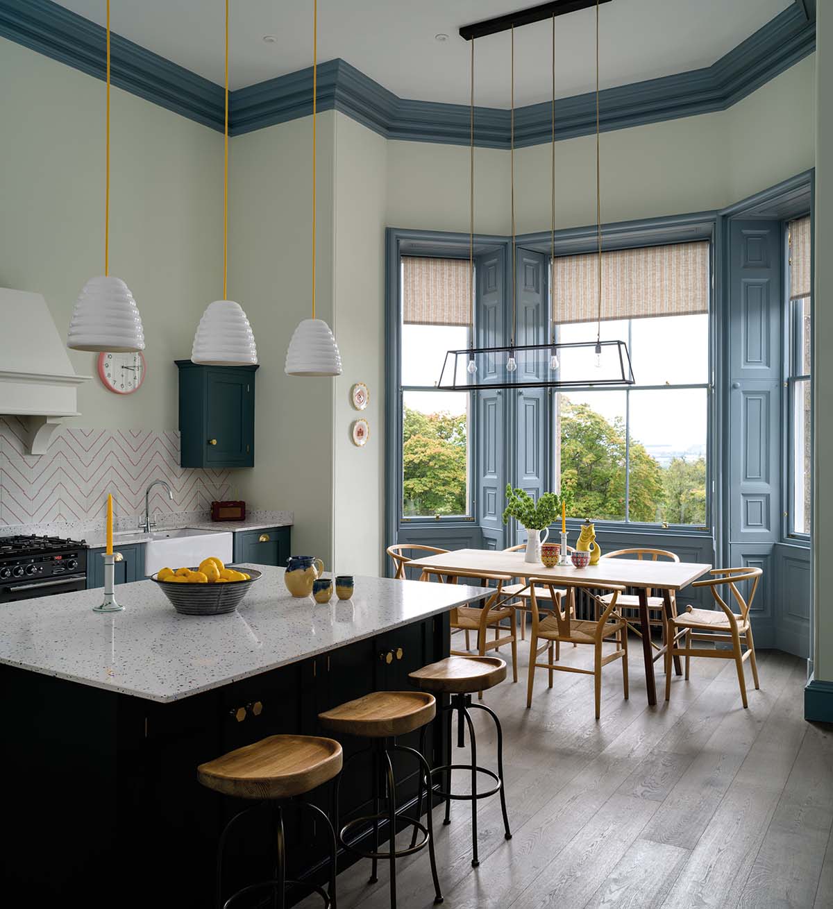 spacious kitchen with breakfasting island, dining table and big windows