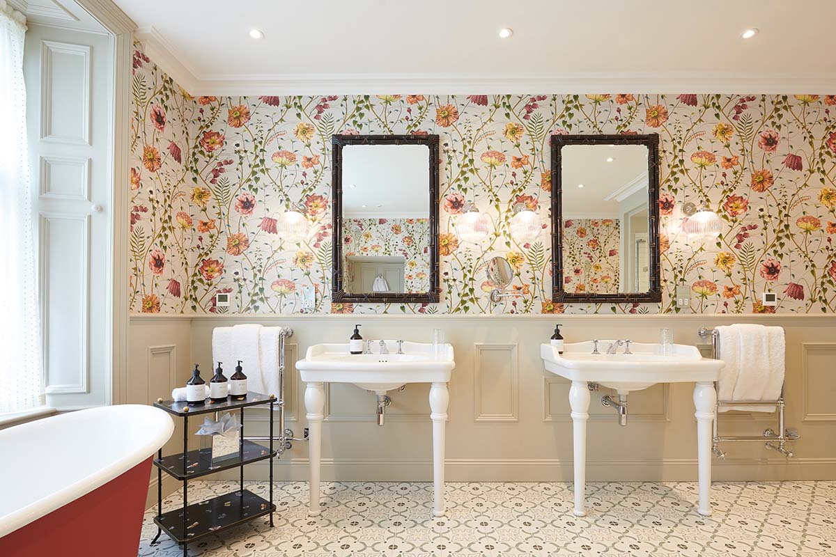 The Alium bathroom at Cromlix, with floral wallpaper and double sink