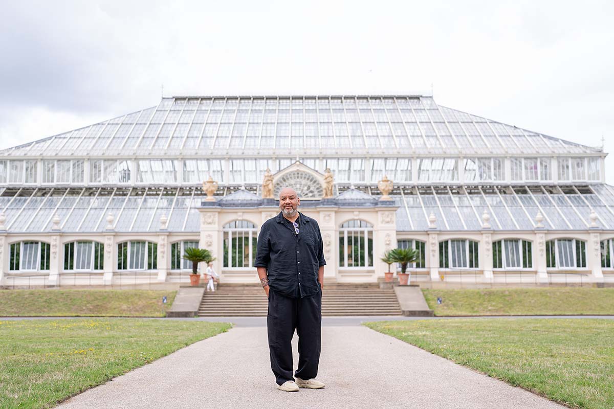 Jeffrey Gibson stands in front of the Temperate House at Kew Gardens