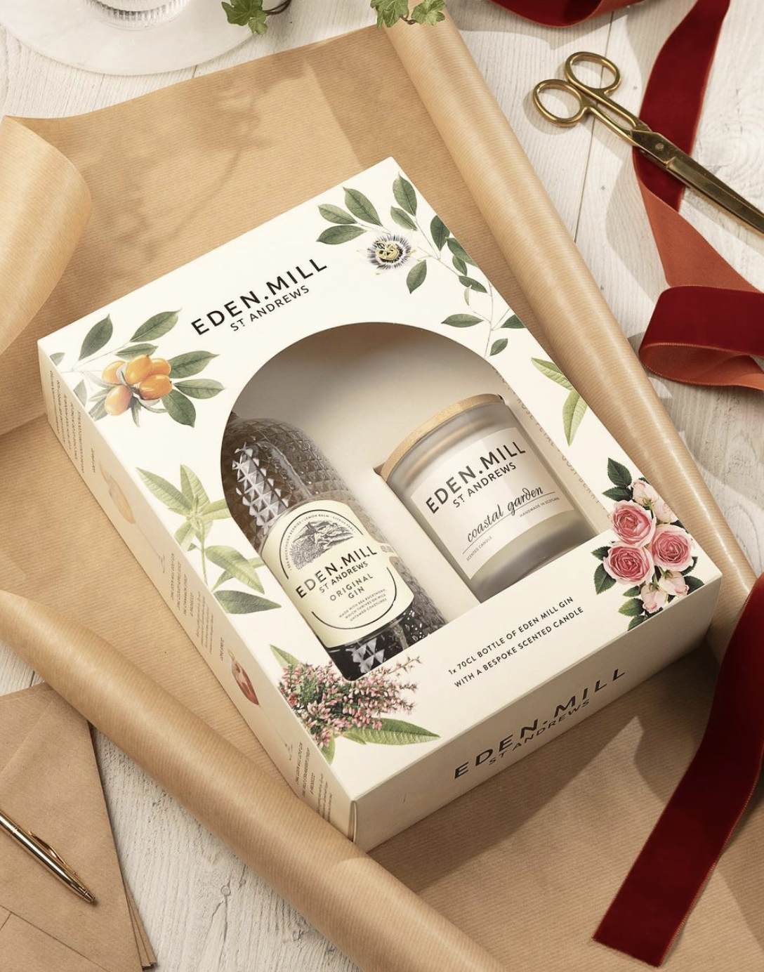 Image of a Christmas gift box of Eden Mill gin with ribbon and brown paper
