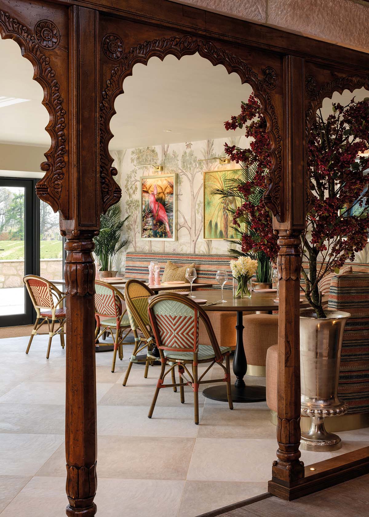 dining table seen through wooden indoor archway at new hotel