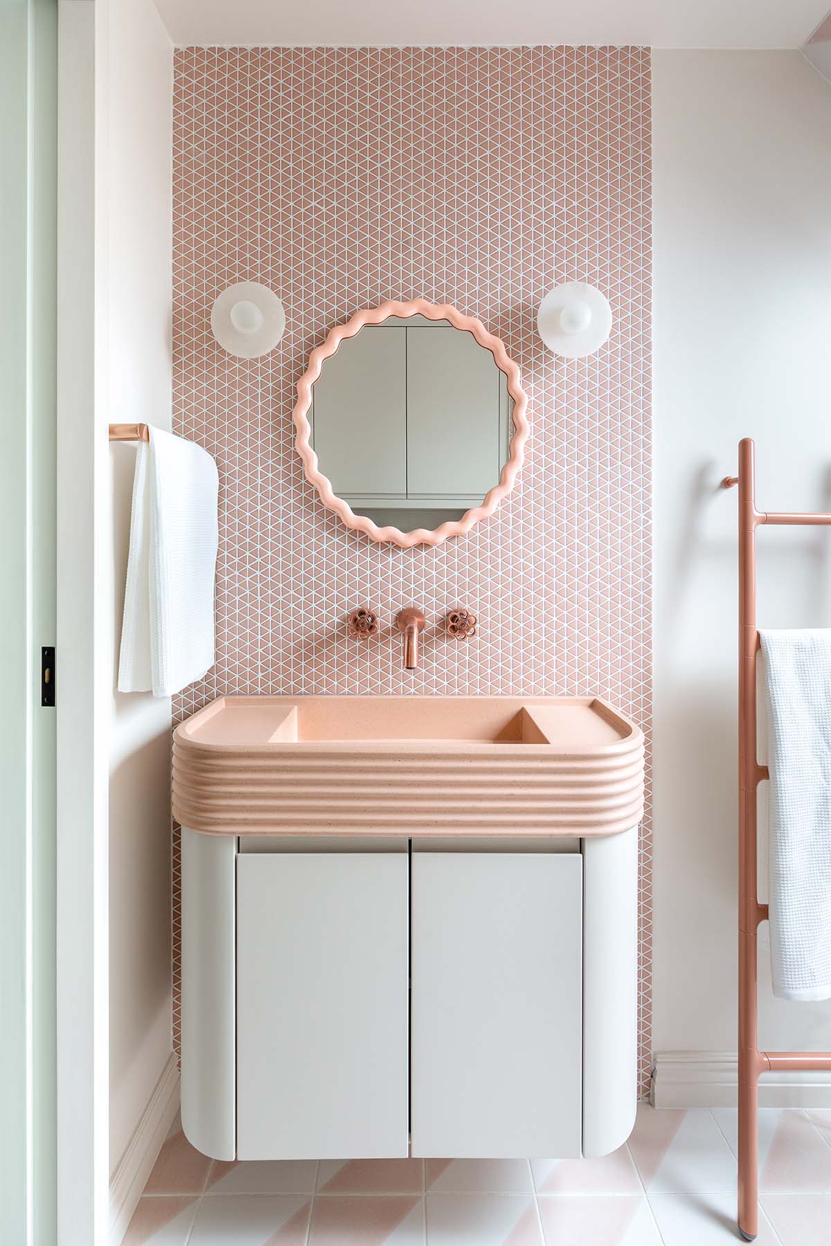 pink vanity unit with sink and mirror