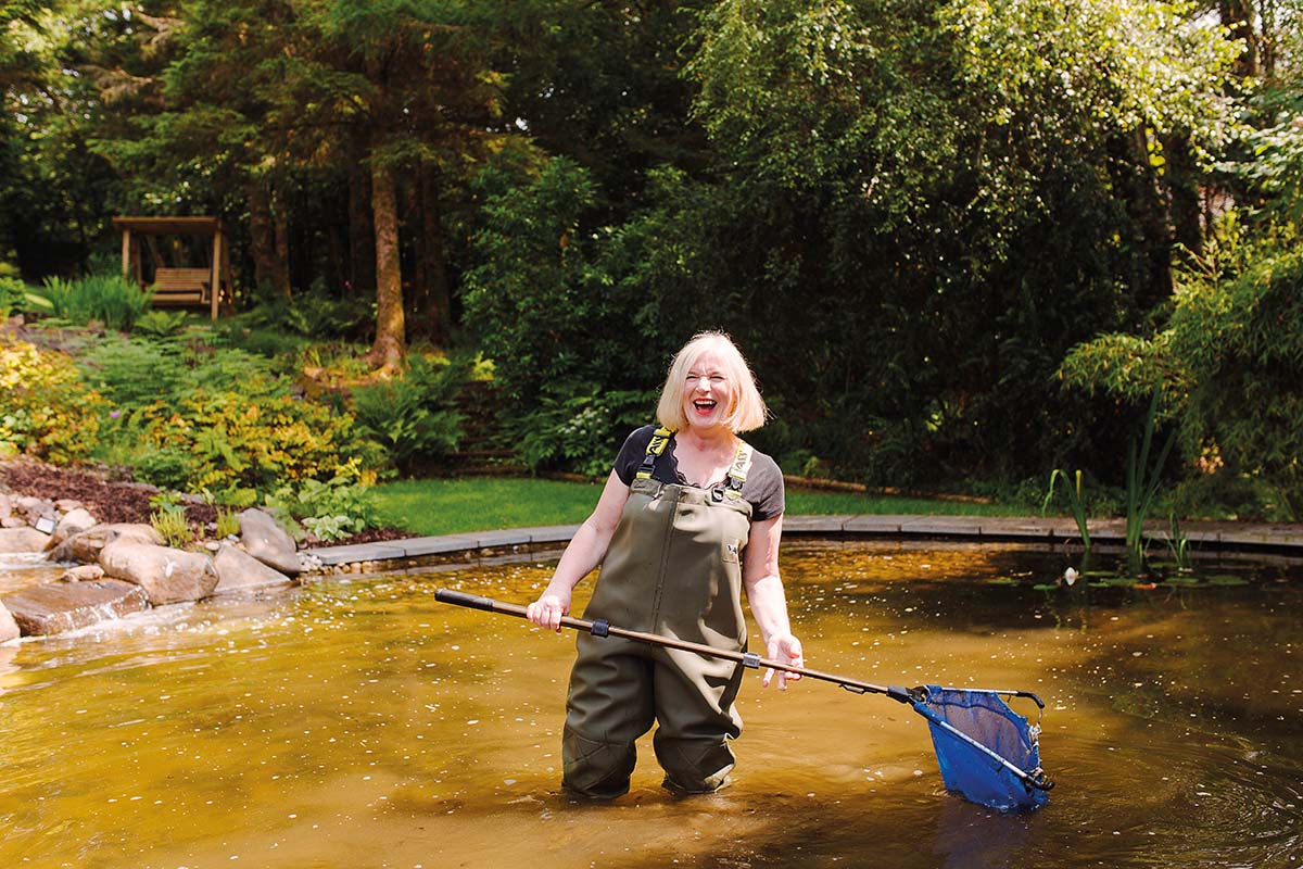 Artist Rosemary Beaton in her garden pond
