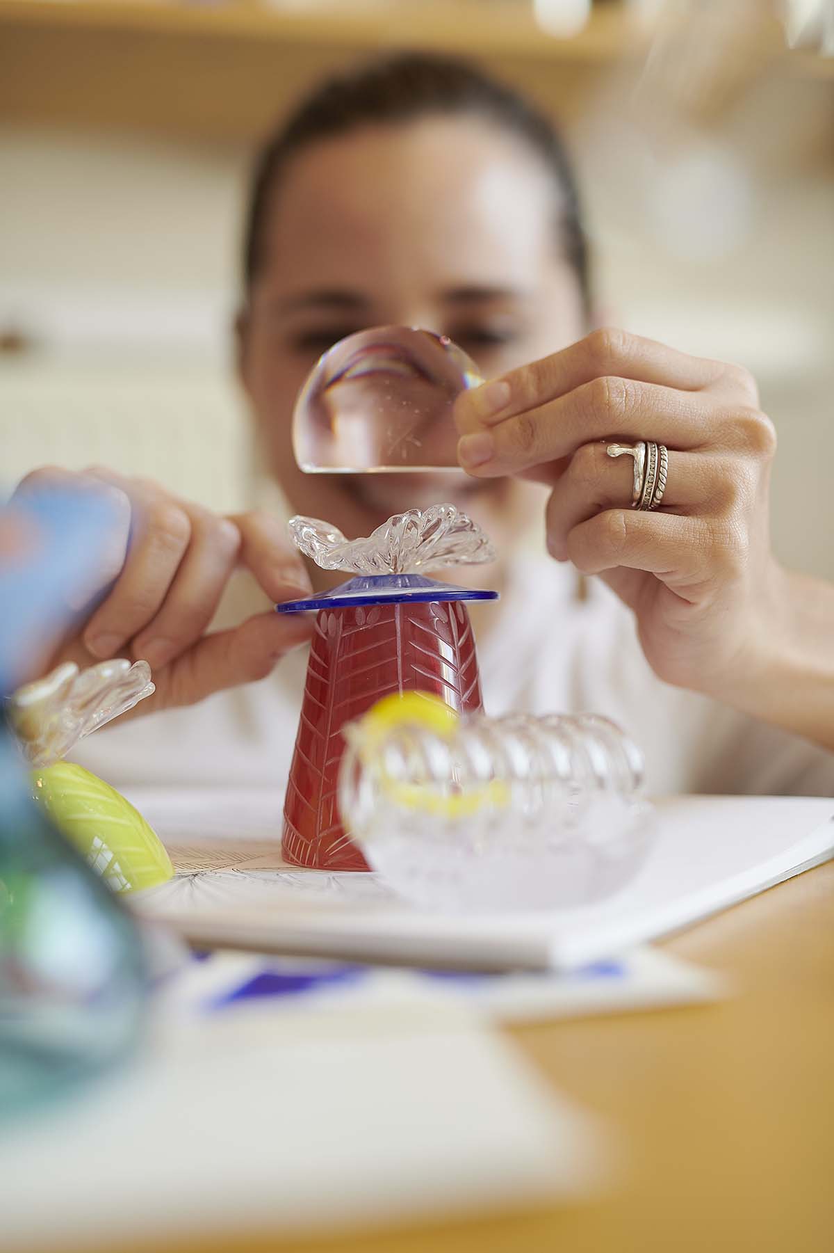 An artist working on a glass sculpture