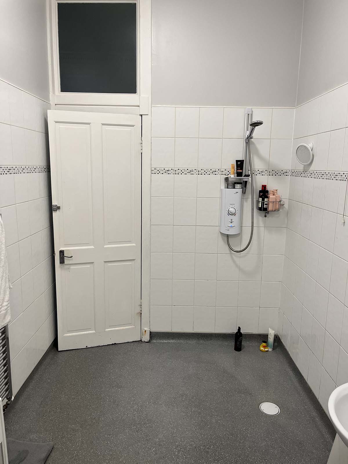 A bathroom with a wet room shower