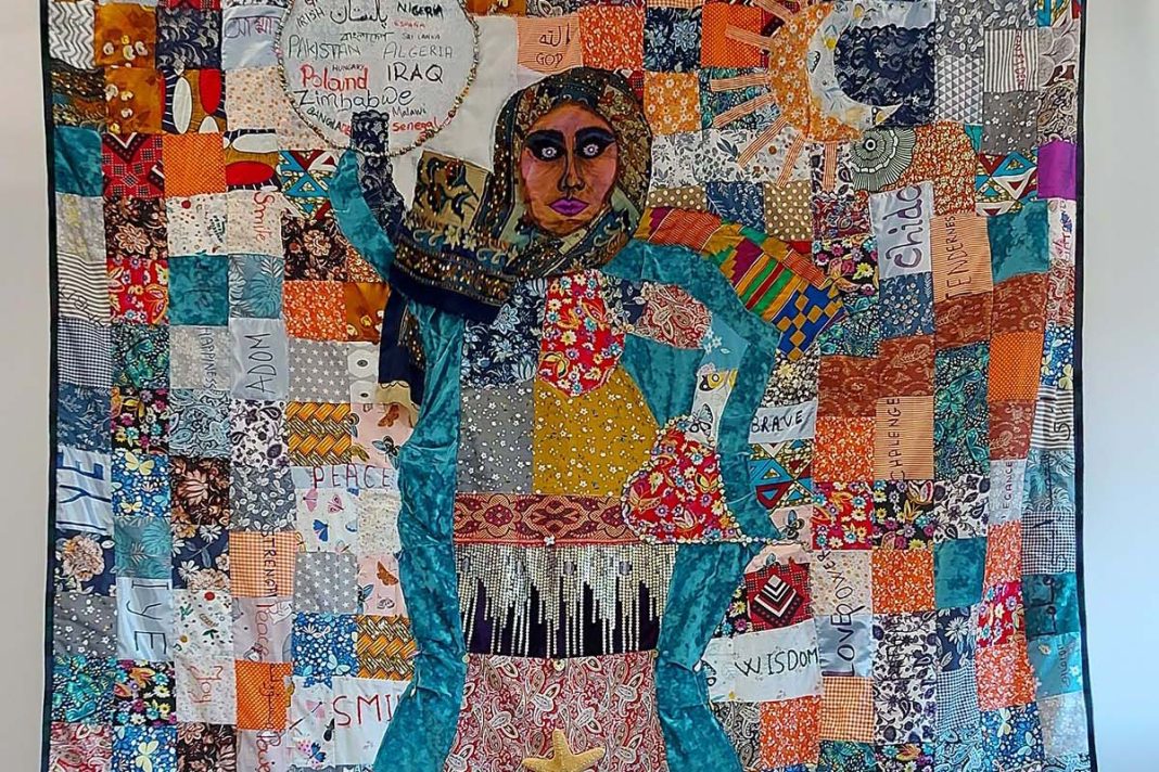 a patchwork quilt depicting a woman wearing a headscarf