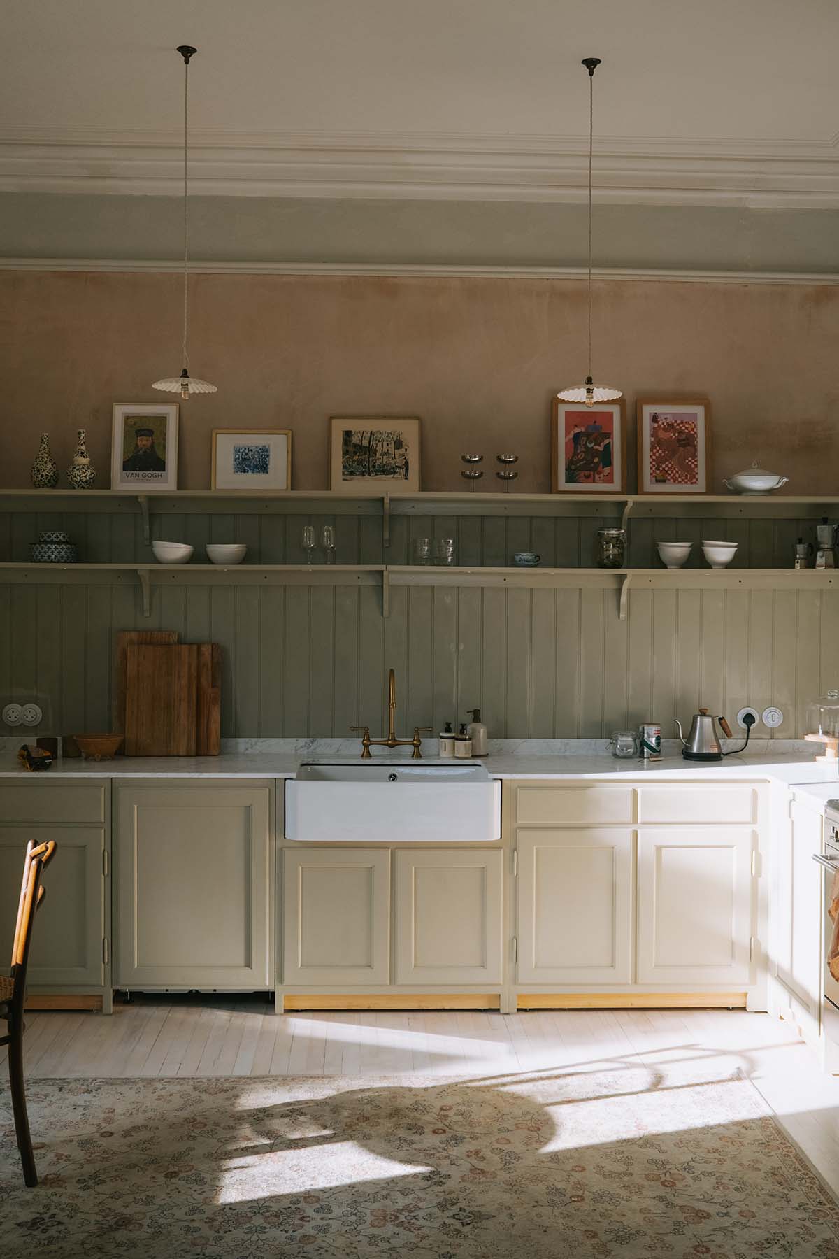 a kitchen with open shelves and pale tones