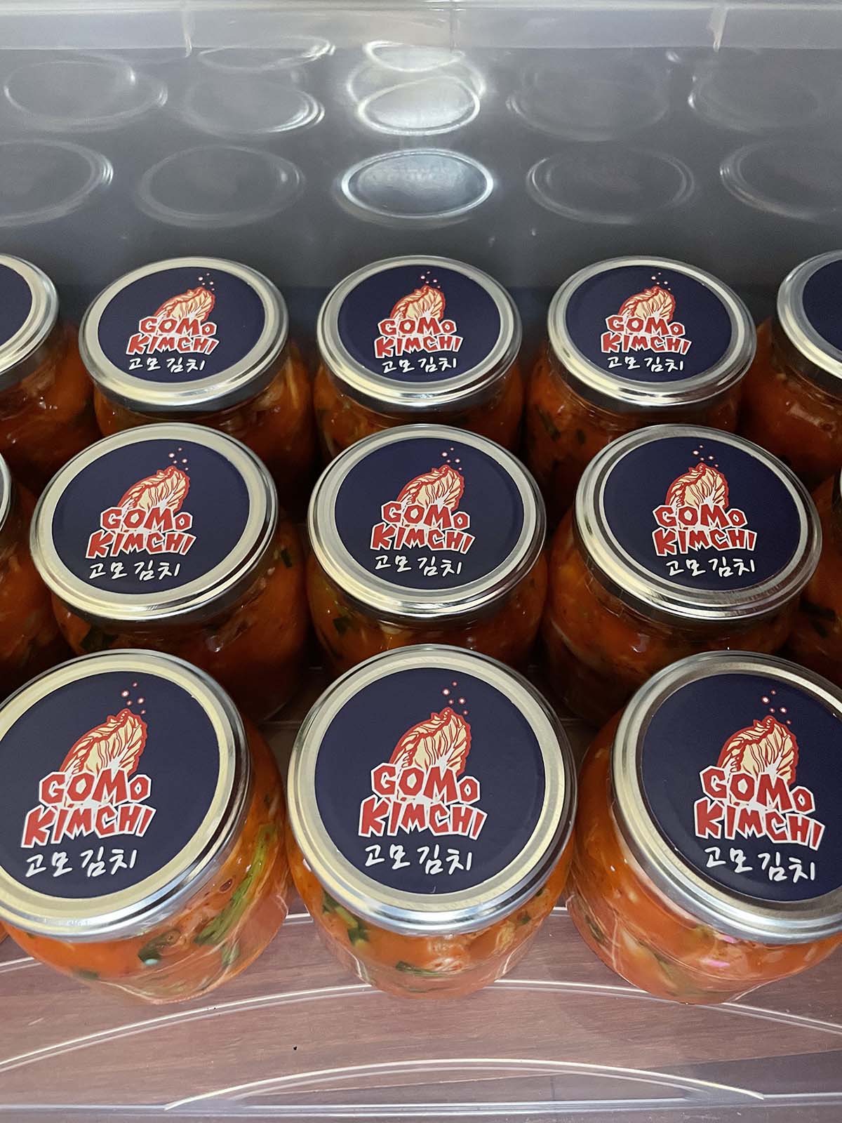 Jars of kimchi with 'Gomo Kimchi' labels on the lids