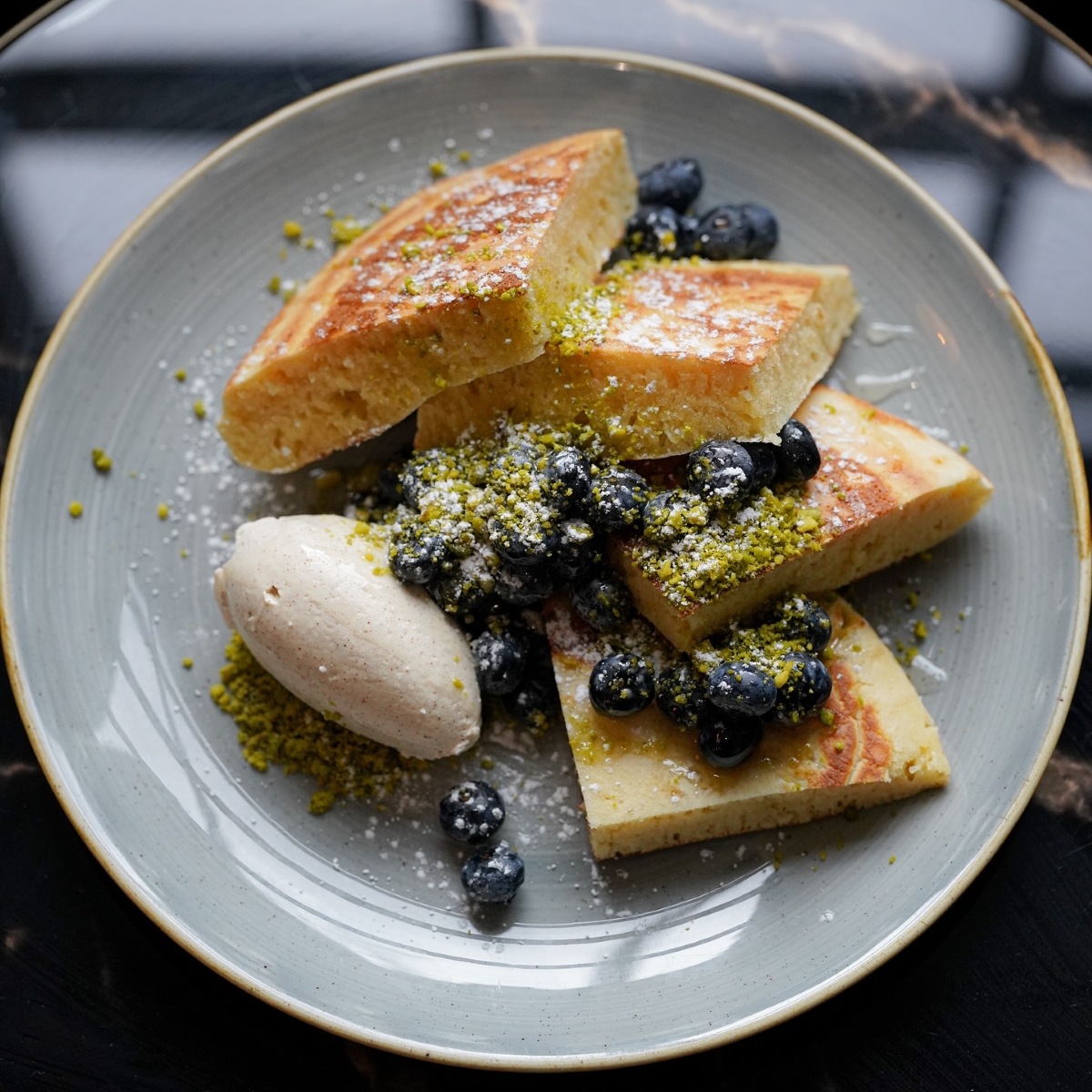 Fluffy pancakes, fresh blueberries, vanilla cream and pistachio French toast from Hillhead Cafe in Inverness - best breakfast in the highlands