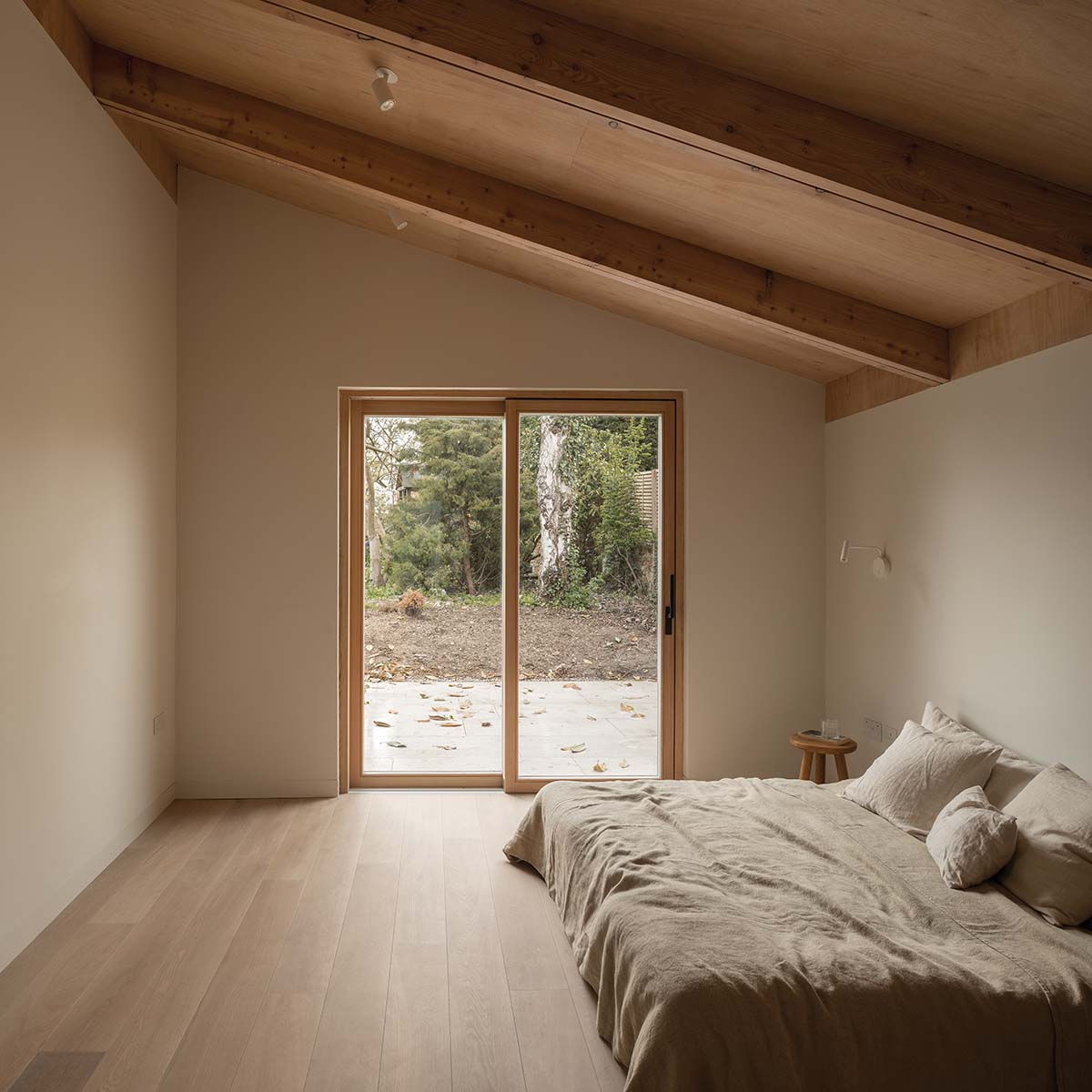 A light and airy bedroom with sliding doors out to the garden area There are no steps to allow wheelchairs to wheel in and out 