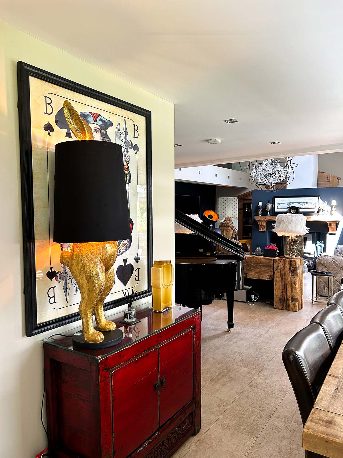 Scotland's Home of the Year episode 5. Image includes unique rabbit lamp, inspired by the mad hatter in Alice in Wonderland. Also pictured are leather dining chairs with solid wood dining table, grand piano, chandelier and grey couches.