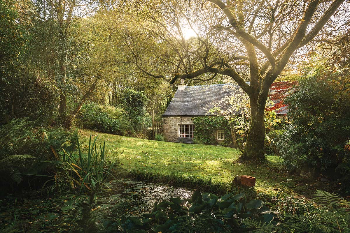 Little Eden mill house sits on the bonnie banks of Loch Lomond. Here, we see the exterior, surrounded by greenery - a truly secret haven