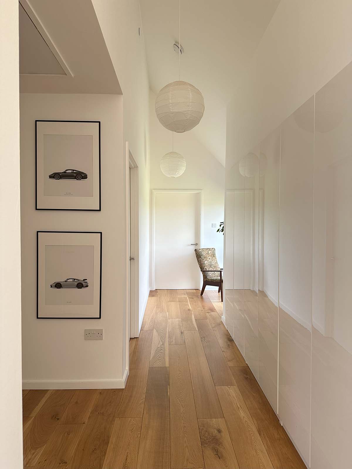 Main hallway featuring white cabinetry and floor-to-ceiling wardrobes