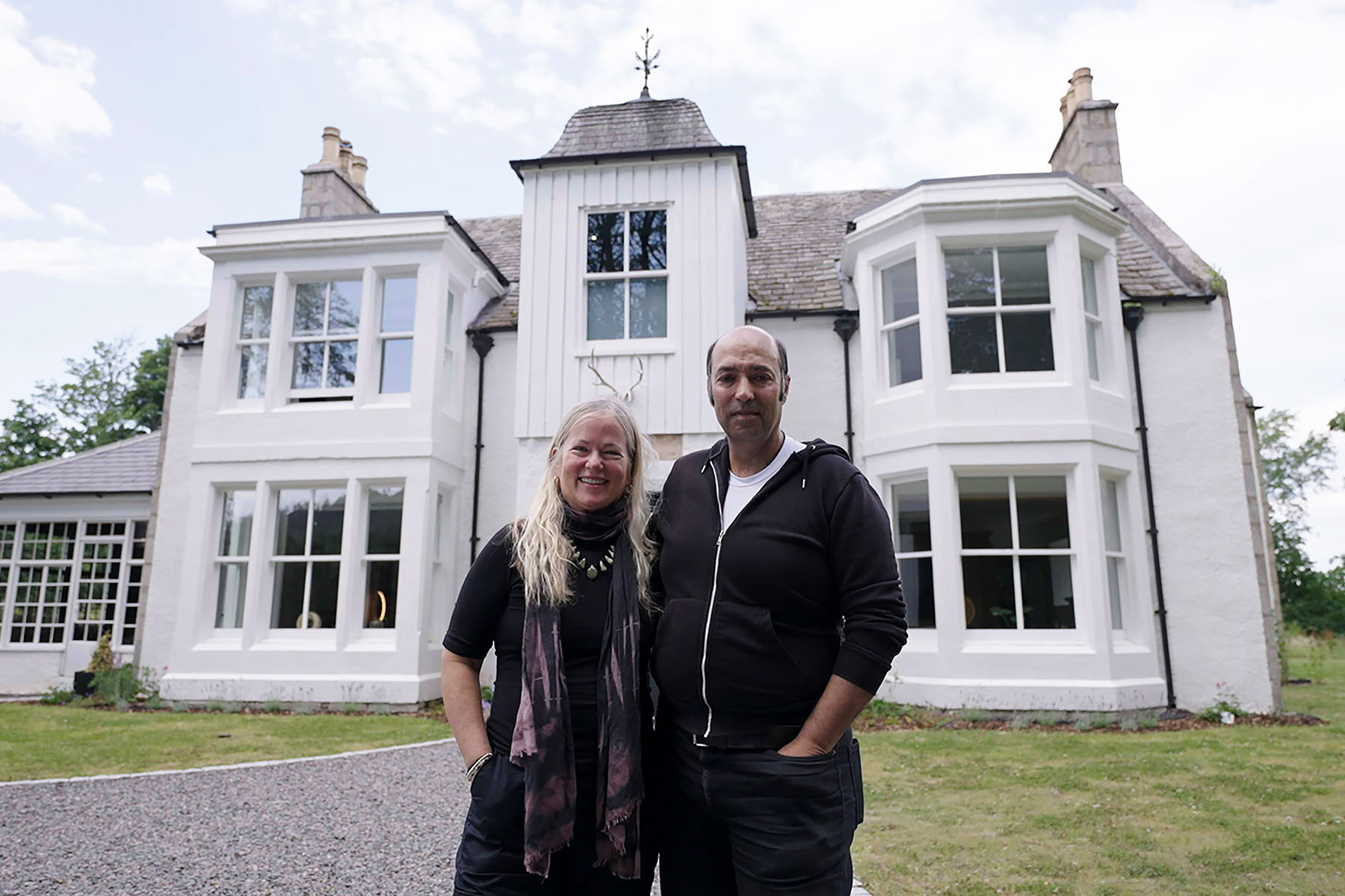 Owners of the Earth House in Scotland stand in front of their property for Scotland's Home of the Year