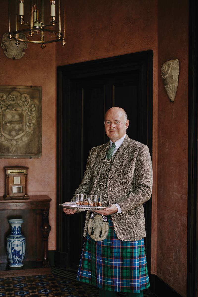 Staff in traditional Scottish kilt in old holiday stay near Loch Ness