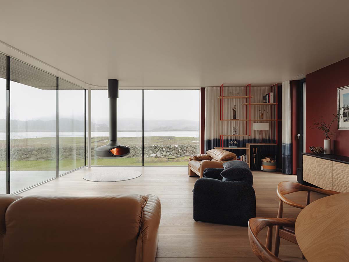 Living room and floating fireplace in the expansive living room of eco house in Dumfries and Galloway