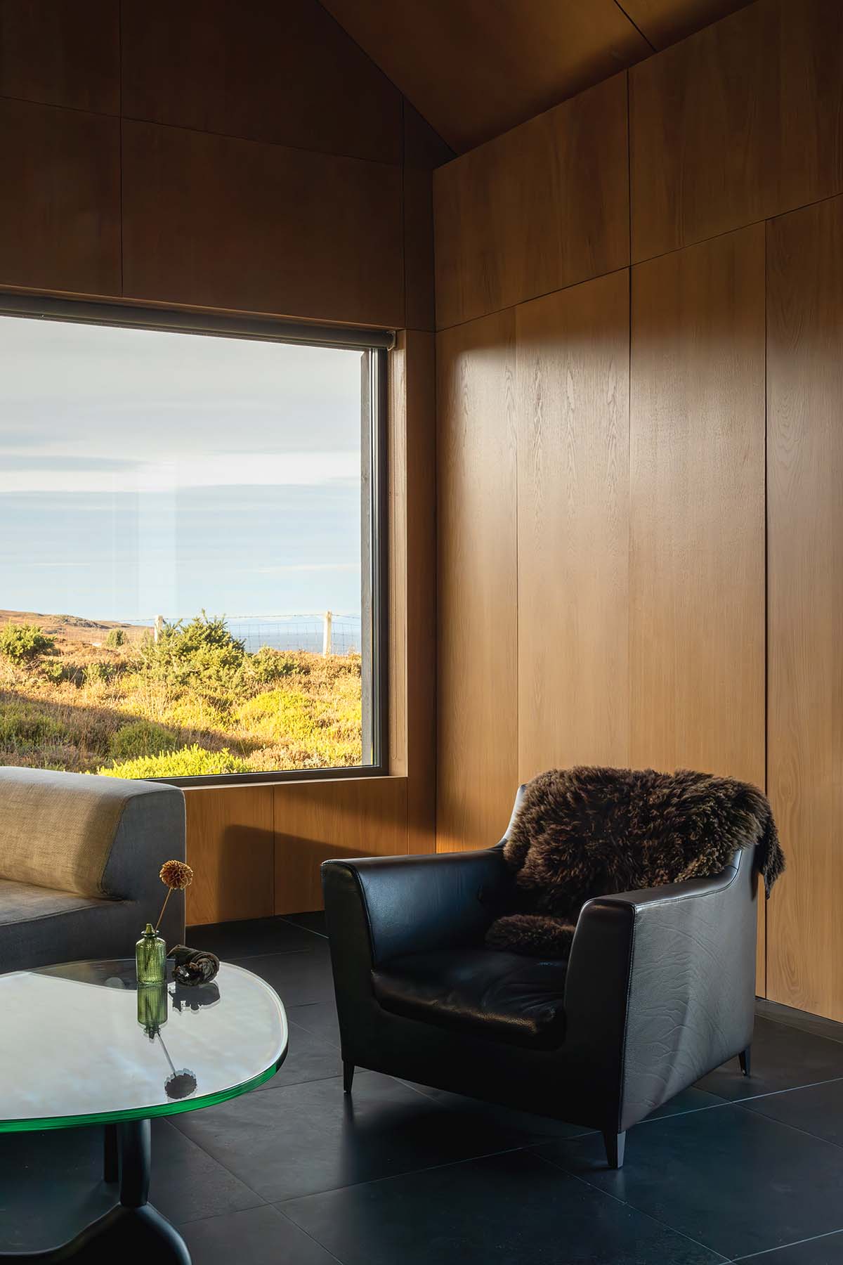 living area with leather armchair and a seaside view on the isle of skye in scotland