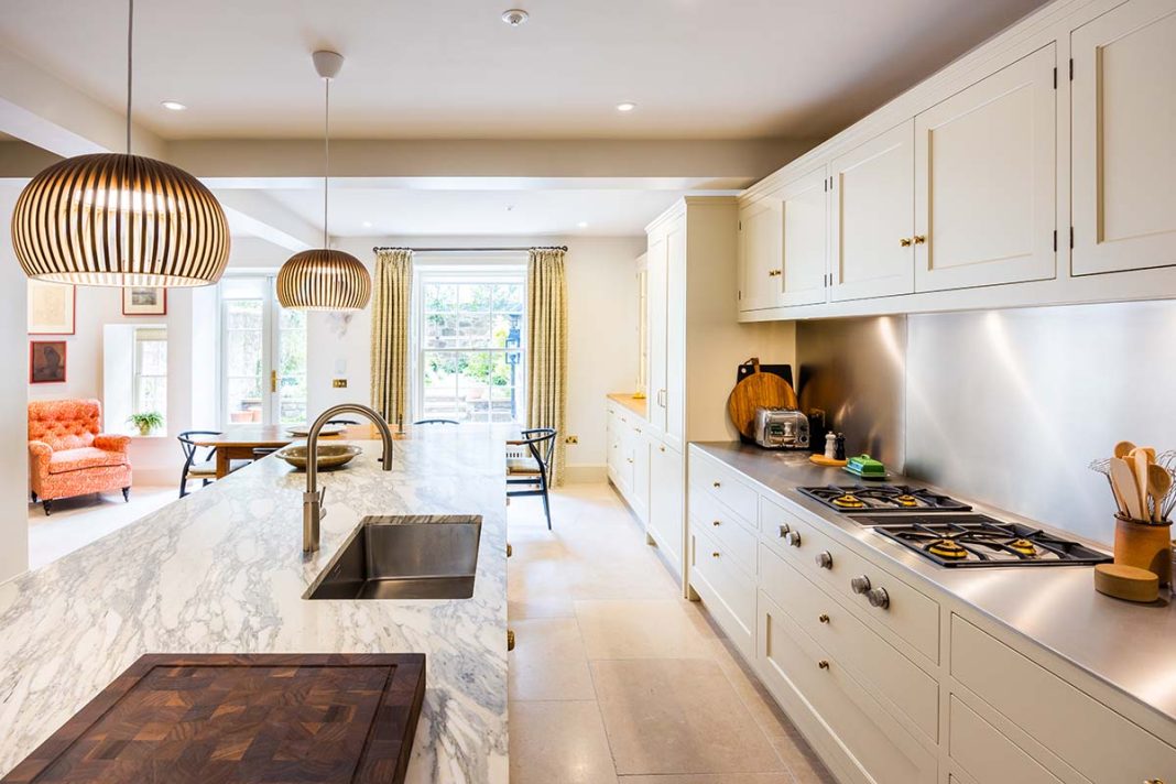 kitchen with marble countertops and white cabinerty