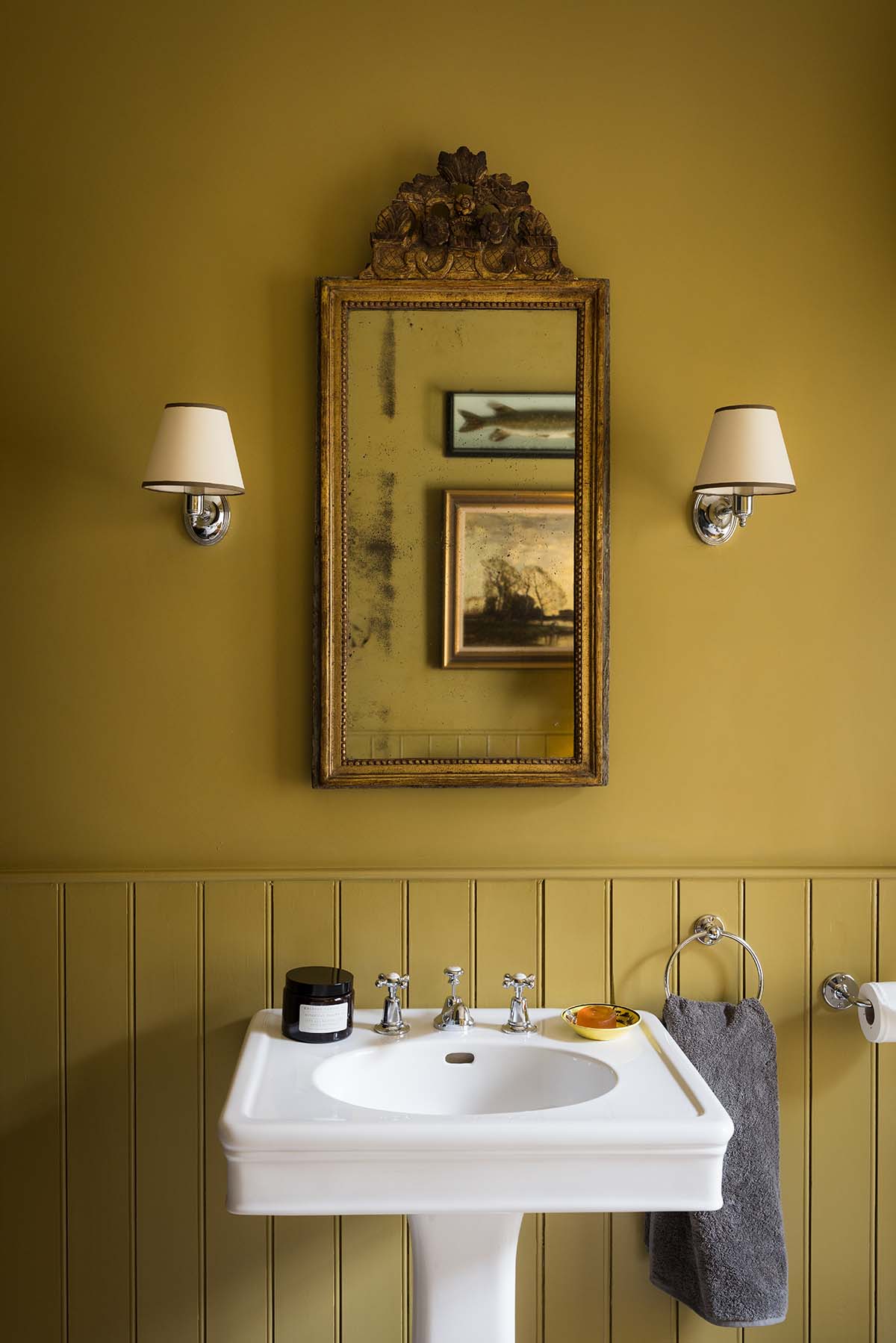 bathroom sink with green walls