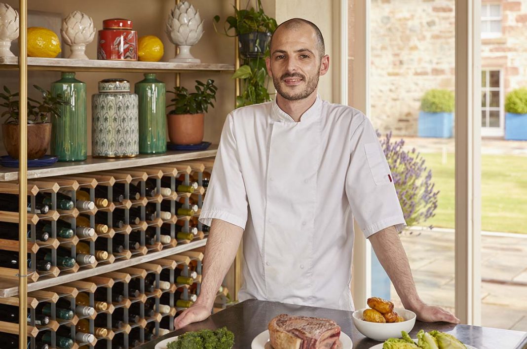 head chef for Newhall Mains, Alex Hendesron standing in restaurant