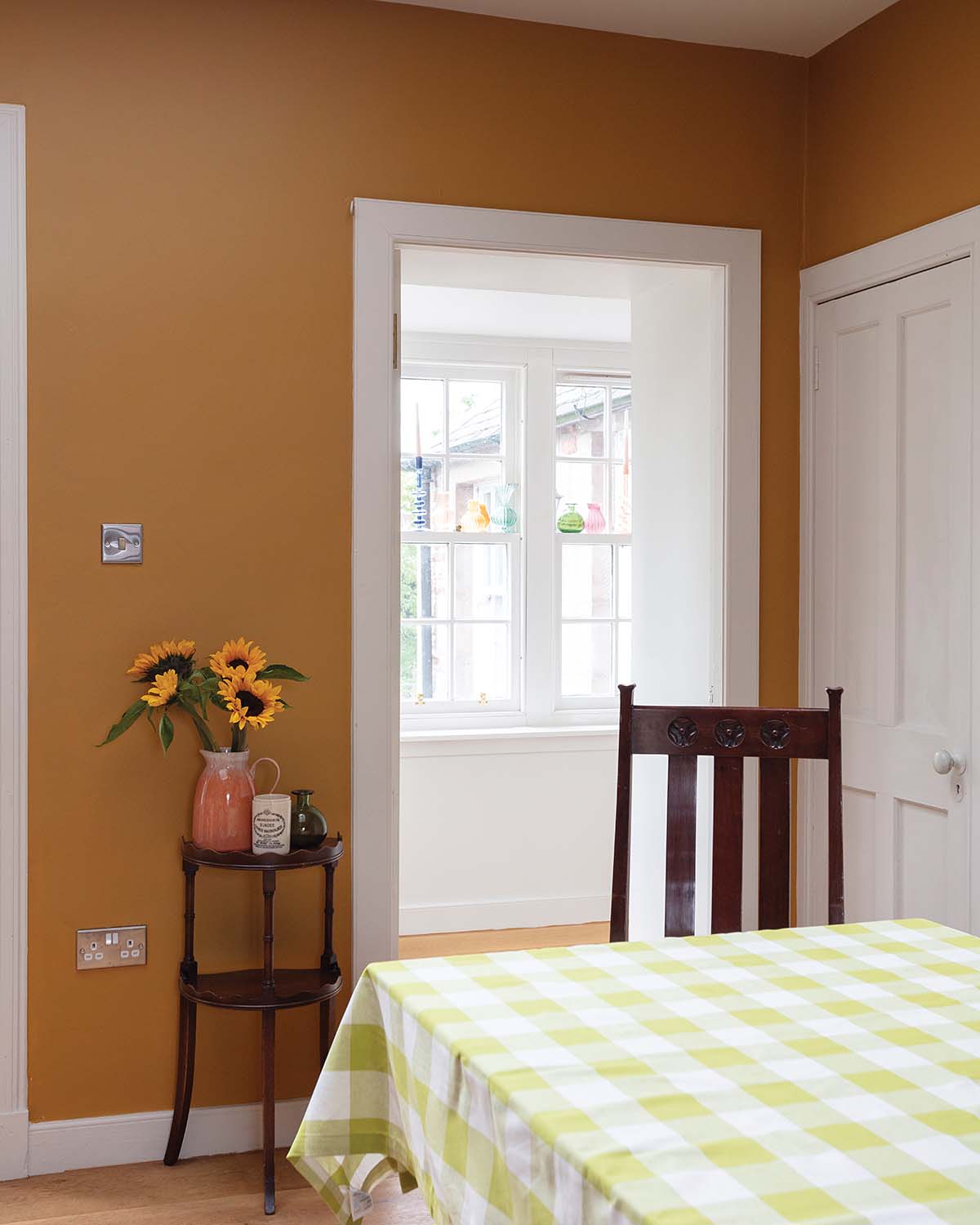 dining table in the kitchen with pale green and white gingham classic table cover