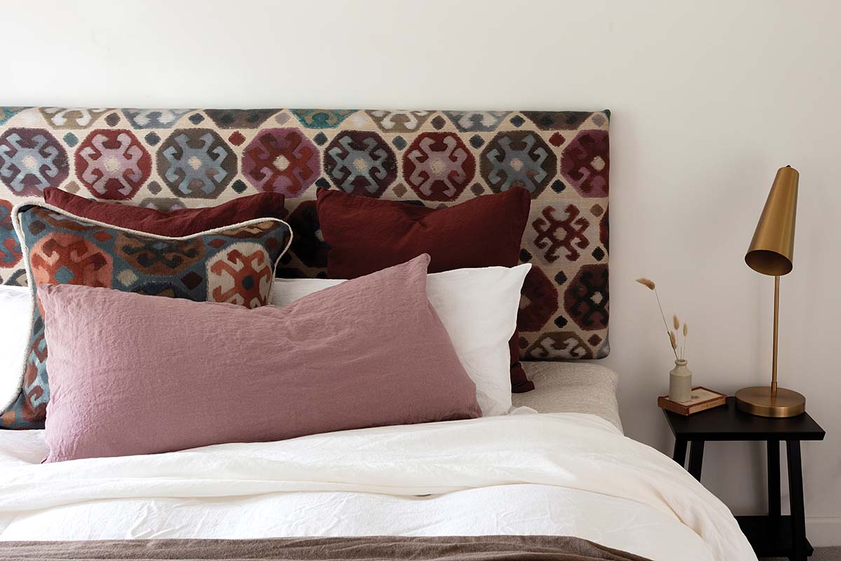 bedroom with floral headboard on master bed