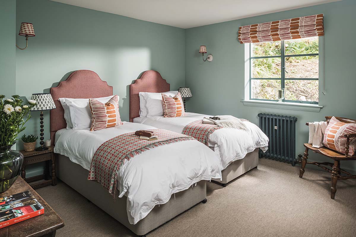 bedrooms in cottage getaway by boutique hotels website on the isle of mull in scotland with green walls and pink bedding