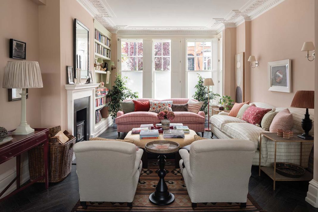 living room with twee wallpaper and large sofas in front of bay window, designed by Jessica Buckly Onepoint