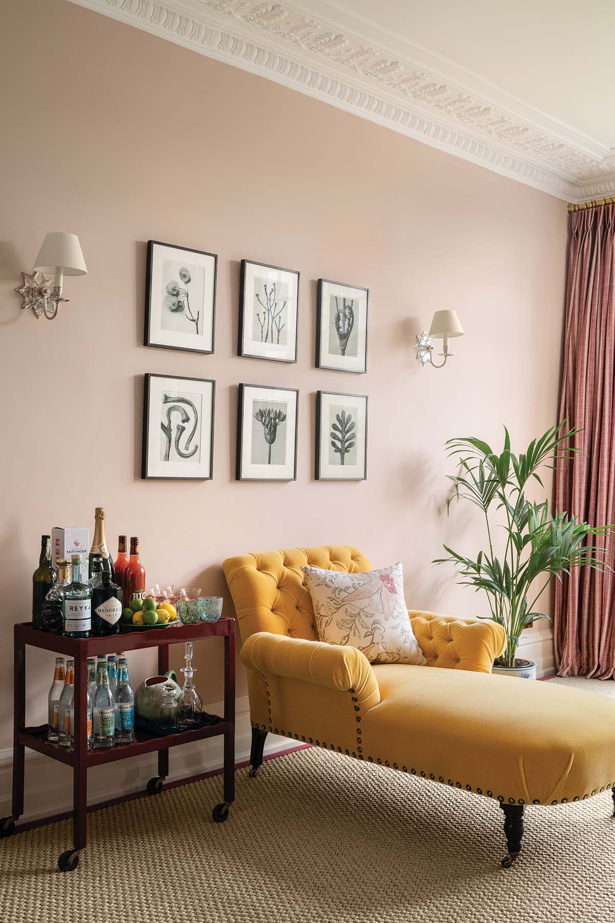 yellow chaise longue in colourful home with gallery wall